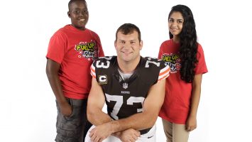 Martin Luther King Academy for Boys student Brandon Barkley (left) and Solon Middle School Student Izma Khaliq (right) pose with Browns offensive tackle Joe Thomas. Barkley, Khaliq and Thomas are featured in new educational videos from the American Dairy Association Mideast. Details: http://bit.ly/185EwFw