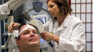 A technician calibrates a transcranial magnetic stimulation (TMS) machine during a therapy session at UCLA Health. Bob Holmes, of Los Angeles, is being treated with TMS for depression, but experts at UCLA want to study the therapy to see if it can be an effective alternative to opioids for patients with chronic pain.