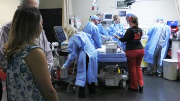 A mother looks on as the pediatric trauma team at Orlando Health Arnold Palmer Hospital for Children cares for her son. A new survey shows that 90 percent of Americans think parents should be able to stay with their child rather than being confined to a waiting room.