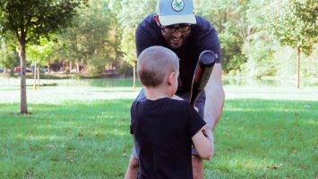 Matt Hurt shows his five-year-old son how to swing a baseball bat. A new study suggests that fathers can give their children a genetic head start on a healthy metabolism by exercising prior to conception.