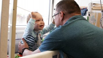 Joe Shields plays with his son, Jack, in his hospital room. A new approach to treatment for a chronic lung disease developed at Nationwide Children’s Hospital helped Jack grow strong enough to finally be discharged from the hospital after 19 months.