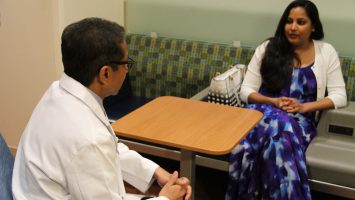 Dr. Naren Ramakrishna speaks with a patient, Rhea Birusingh, before she undergoes proton therapy to treat a tumor found behind her eye during her pregnancy. Rhea is the first patient to be treated at the new proton therapy center at UF Health Cancer Center - Orlando Health.